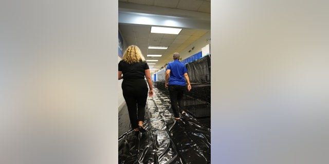 Volunteers walk through a school that is now a storm shelter this week in Seminole County, Florida.