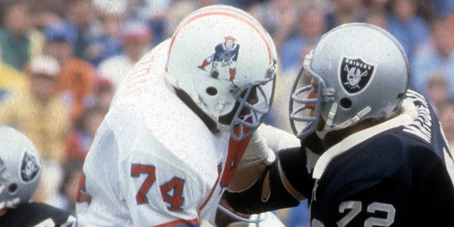 John Matuszak of the Oakland Raiders, right, is blocked by Shelby Jordan of the New England Patriots during a game at Foxboro Stadium in Foxboro, Massachusetts, circa 1979.