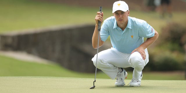 Jordan Spieth of the United States Team lines up his putt on the tenth hole during the Thursday foursome matches on day one of the 2022 Presidents Cup at Quail Hollow Country Club on September 22, 2022 in Charlotte, North Carolina.
