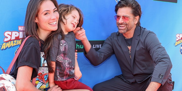 John Stamos and his family of three attended a Spider-Man themed event at the Santa Monica Pier.