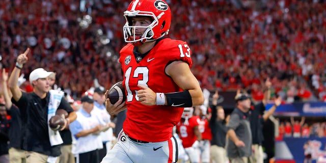 Stetson Bennett #13 of the Georgia Bulldogs rushes in for a touchdown during the first half against the Oregon Ducks at Mercedes-Benz Stadium on September 3, 2022 in Atlanta, Georgia.