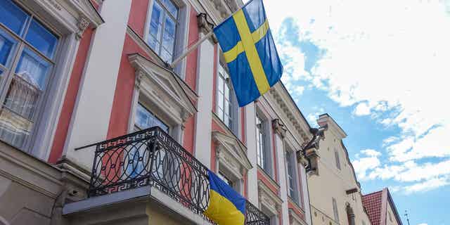 Sweden, their flag pictured above in Tallinn, Estonia, on July 31, 2022, is set to become a member of NATO after working with Turkey to end an arms embargo that was leveraged against Turkey after its military operation against the Kurds in Syria.