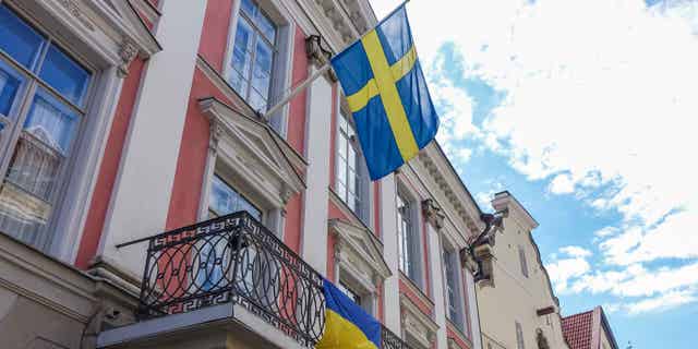 Sweden, their flag pictured above in Tallinn, Estonia, on July 31, 2022, is set to become a member of NATO after working with Turkey to end an arms embargo that was leveraged against Turkey after its military operation against the Kurds in Syria.