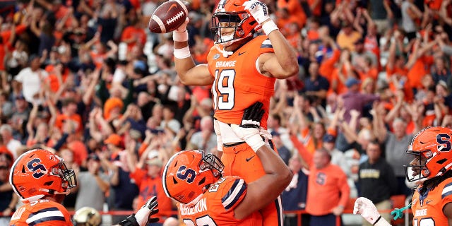 Matthew Bergeron #60 takes on Oronde Gadsden of the Syracuse Orange after Gadsden II scored a touchdown in the fourth quarter against the Purdue Boilermakers at the JMA Wireless Dome on September 17, 2022 in Syracuse, NY. Lift II #19. 