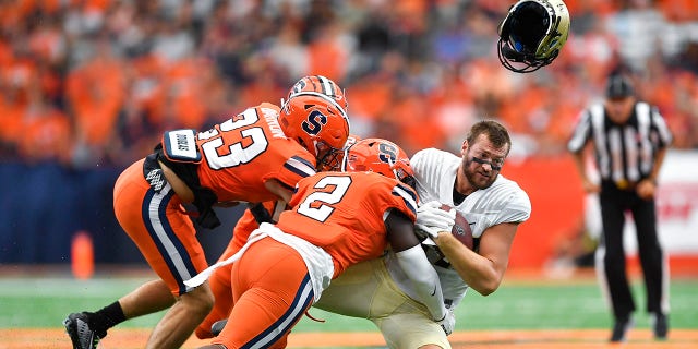 Purdue University on Saturday, Sept. 17, when he was tackled by Syracuse linebacker Marlowe Wax, 2, and defensive back Justin Barron, 23, in the first half of an NCAA college football game in Syracuse, N.Y. tight end Payne Durham (right) lost his helmet.  , 2022.