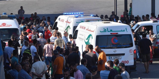 Lebanese people arrive at the Syrian border in Arida, Lebanon, on Sept. 23, 2022, to identify and retrieve the bodies of loved ones who died when their boat sank off the coast of Syria.
