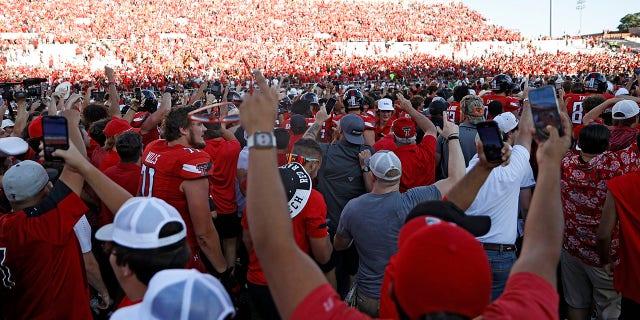 Texas Tech fans celebrate on the field after an NCAA college football game against Texas, Saturday, Sept. 24, 2022, in Lubbock, Texas.