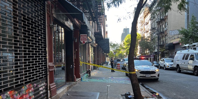 Crime scene tape cordons off the scene where a smoke shop worker was shot by robbery suspects on the Lower East Side.