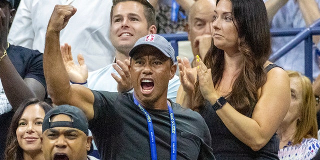 Golf legend Tiger Woods did a fist pump to cheer on tennis star Williams. 