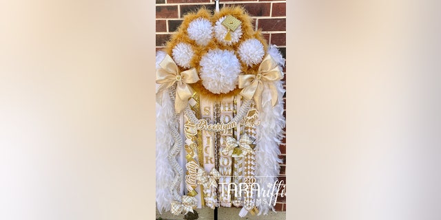 This particular mum, as requested by the customer, resembles a paw print with multiple mum flowers. When a "student squeals in delight," mum maker Tara O'Donnell of Houston said she knows she's fulfilled the client's request.