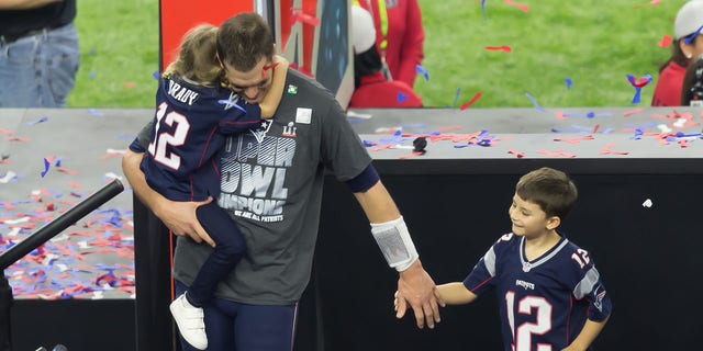 Tom Brady (12) walks his children off the victors' podium during the Super Bowl LI between the New England Patriots and Atlanta Falcon on February 5, 2017, at NRG Stadium in Houston, Texas. 