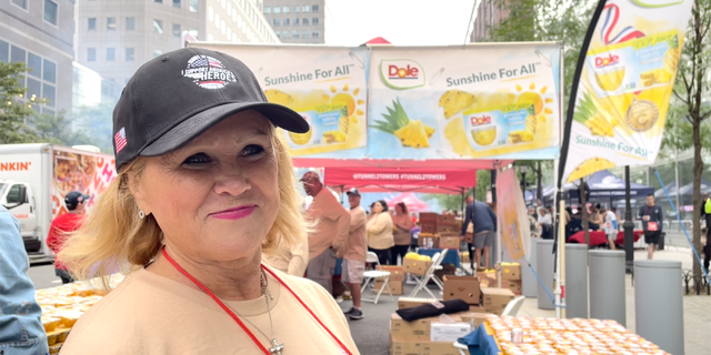 Tunnel to Towers volunteer Tricia Foley hands out Dole fruit cups at the organization's annual 5K race in New York City on Sunday, Sept. 25, 2022.