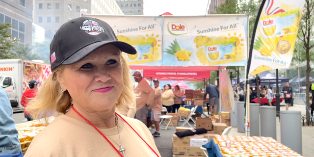 Tunnel to Towers volunteer Tricia Foley hands out Dole fruit cups at the organization's annual 5K race in New York City on Sunday, Sept. 25, 2022.