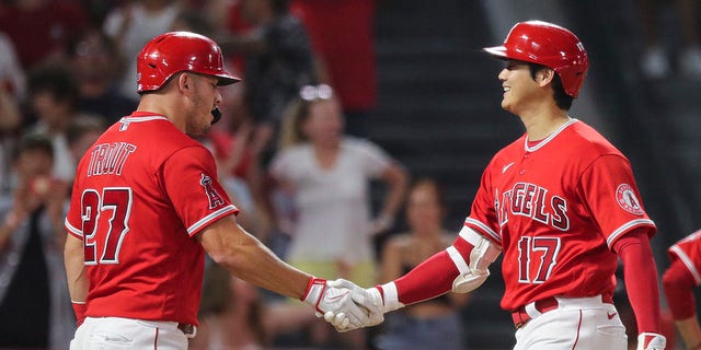 Shohei Ohtani (17) of the Los Angeles Angels celebrates a two-run home run with Mike Trout (27) in the third inning against the Detroit Tigers at Angel Stadium of Anaheim on September 5, 2022 in Anaheim, California.