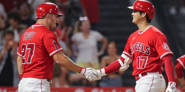 The Los Angeles Angels' Shohei Ohtani (17) celebrates a double home run with Mike Trout (27) in the third inning against the Detroit Tigers at Angel Stadium of Anaheim on September 5, 2022 in Anaheim, California.