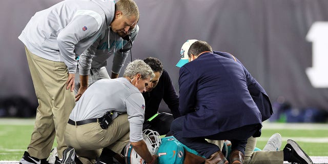 Medical staff tend to quarterback Tua Tagovailoa of the Miami Dolphins after suffering an injury during the second quarter of a game against the Cincinnati Bengals at Cincinnati's Peycoe Stadium on Sept. 29, 2022.