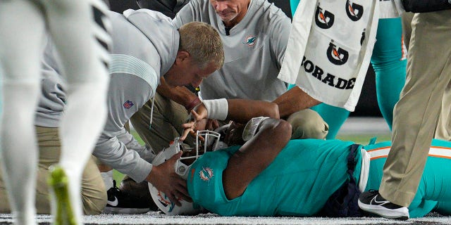 Miami Dolphins quarterback Tua Tagovailoa is examined during the first half of the team's NFL football game against the Cincinnati Bengals, Thursday, Sept. 29, 2022, in Cincinnati. 