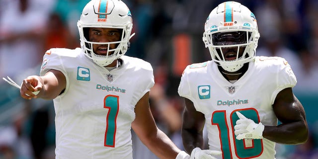 Tua Tagovailoa, #1, and Tyreek Hill, #10 of the Miami Dolphins, in action during the first half of the game against the Buffalo Bills at Hard Rock Stadium on Sept. 25, 2022 in Miami Gardens, Florida.