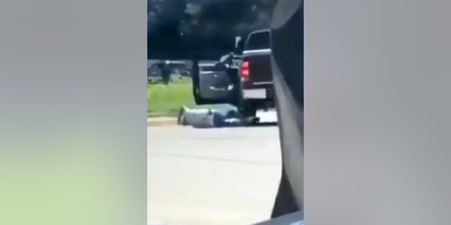 Good Samaritan who stepped in during robbery lies on the ground after suspect took off in a truck.