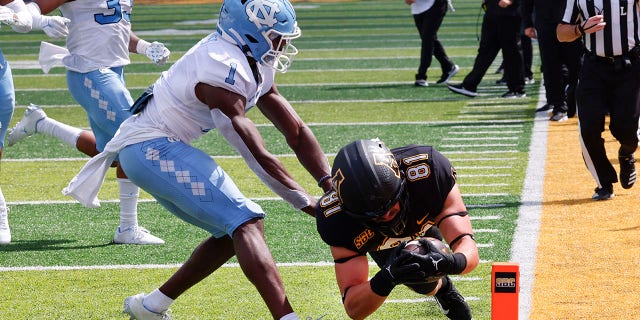 Appalachian State tight end Miller Gibbs (81) dives in for a touchdown past North Carolina defensive back Tony Grimes (1) during the second half of an NCAA college football game, Saturday Sept. 3, 2022, in Boone, N.C.