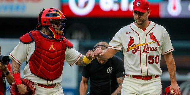 Yadier Molina and Adam Wainwright (50) of the St. Louis Cardinals fist bump as they walk to the dugout prior to a game against the Chicago Cubs at Busch Stadium Sept.  3, 2022 in St.Louis.