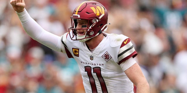 Carson Wentz of the Washington Commanders celebrates throwing a touchdown pass during the second quarter against the Jacksonville Jaguars at FedExField on September 11, 2022 in Landover, Maryland.