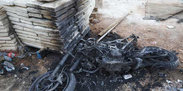 The charred remains of a motorcycle are pictured in Nablus in the occupied West Bank on September 25, 2022, following clashes between Israeli forces and Palestinians militants. - Israeli troops killed a Palestinian militant in the occupied West Bank on Sunday, (AFP via Getty Images)