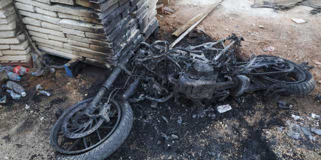 The charred remains of a motorcycle are pictured in Nablus in the occupied West Bank on September 25, 2022, following clashes between Israeli forces and Palestinians militants. - Israeli troops killed a Palestinian militant in the occupied West Bank on Sunday, (AFP via Getty Images)