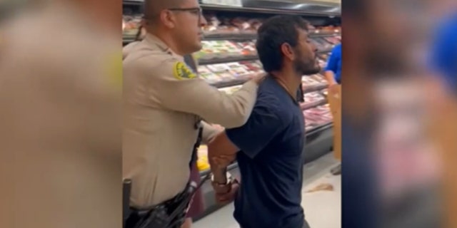Man accused of attacking teen girl inside grocery store bathroom is walked out in handcuffs.