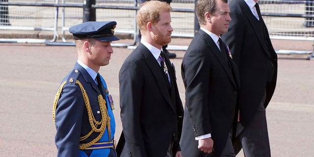 Prince William, left, and Prince Harry, second left, follow the casket of Queen Elizabeth II during a procession from Buckingham Palace to Westminster Hall in London, Wednesday, Sept. 14, 2022. The queen will lie in state in Westminster Hall for four days before her funeral Monday, Sept. 19. 