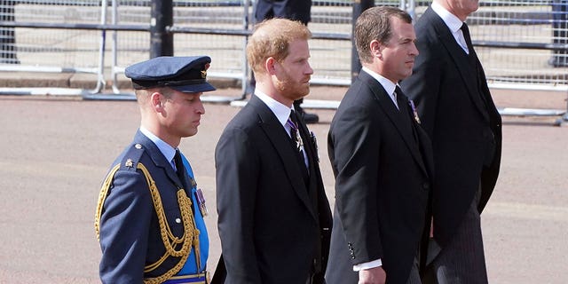 Prince William, left, and Prince Harry, second left, follow the casket of Queen Elizabeth II during a procession from Buckingham Palace to Westminster Hall in London, Wednesday, Sept. 14, 2022. The queen will lie in state in Westminster Hall for four days before her funeral Monday, Sept. 19. 