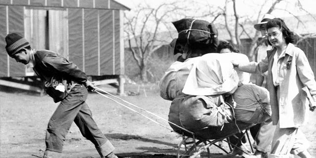 Japanese evacuees move into a war relocation authority center in Manzanar, California, on June 19, 1942.