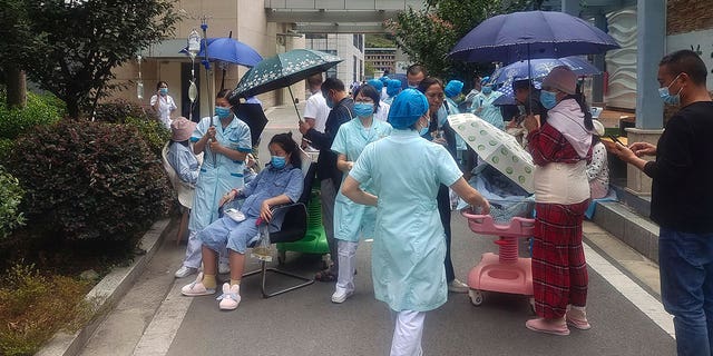 In this photo released by Xinhua News Agency, medical workers transfer patients to safe area at Renmin Hospital of Shimian County in Ya'an City, in the aftermath of an earthquake in southwestern China's Sichuan Province, Monday Sept. 5, 2022.