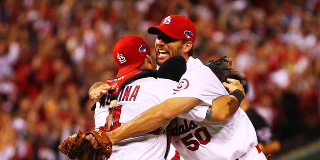 Adam Wainwright (right) celebrates with the St. Louis Cardinals' Yadier Molina after defeating the Pittsburgh Pirates in Game 5 of the National League Division Series on October 9, 2013 at Busch Stadium in St. Louis, Missouri.