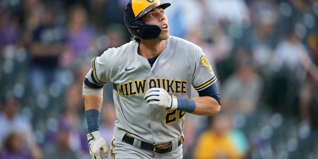 Milwaukee Brewers' Christian Yelich follows the flight of his solo home run off Colorado Rockies starting pitcher Chad Kuhl in the first inning of a baseball game Tuesday, Sept. 6, 2022, in Denver.