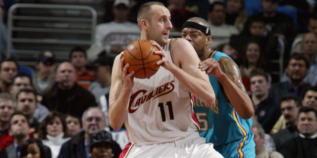 Zydrunas Ilgauskas #11 of the Cleveland Cavaliers posts up Sean Rooks #45 of the New Orleans Hornets during the game at Gund Arena on December 23, 2003 in Cleveland, Ohio.  The Cavaliers won 97-86. 
