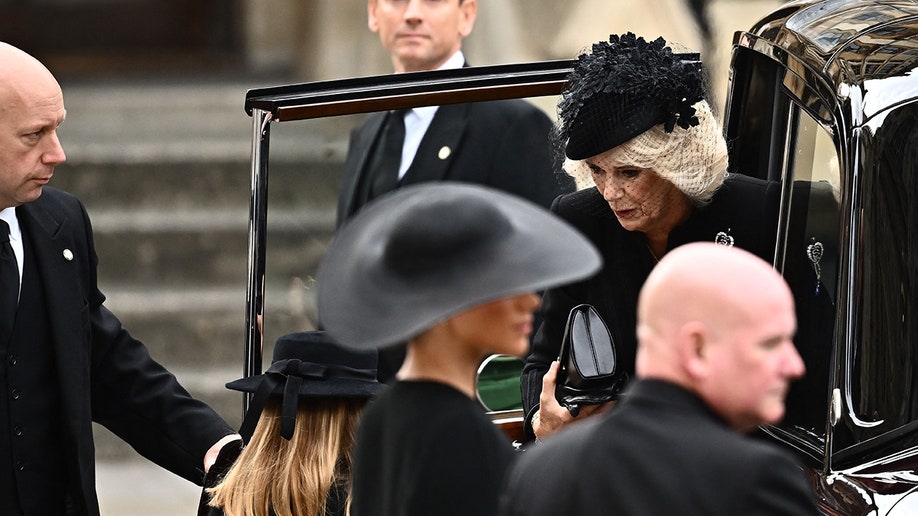 Queen Consort Camilla exits her car at Westminster Abbey ahead of Queen Elizabeth's state funeral