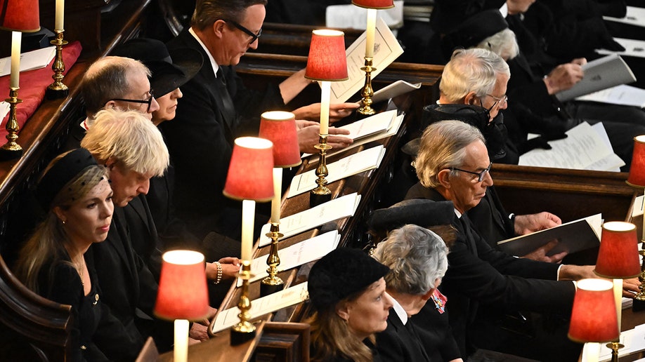 Boris Johnson, Theresa May, David Cameron, Gordon Brown, Tony Blair and John Major and their spouses sit in pews at Westminster Abbey for Queen Elizabeth's state funeral