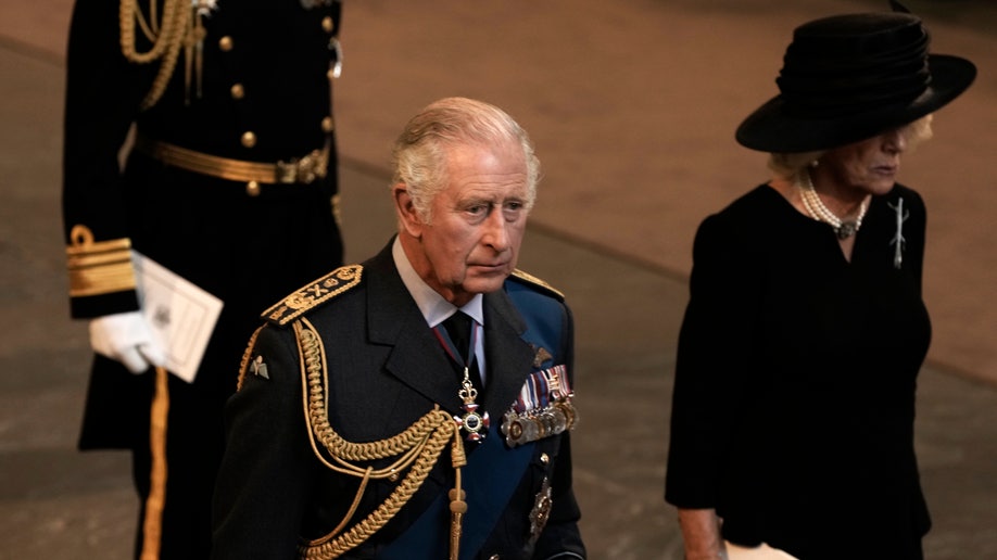 Charles and Camilla wear black as they walk out of Westminster Hall