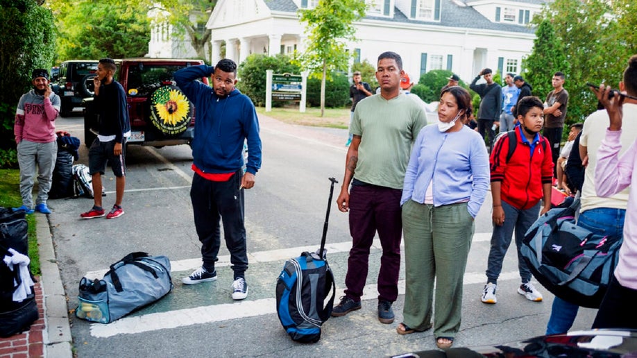 Immigrants gather with their belongings
