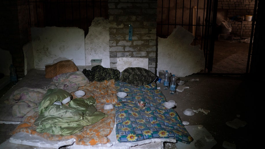 Duvets and sleeping bag are seen in a basement which, according to Ukrainian authorities, was used as a torture cell
