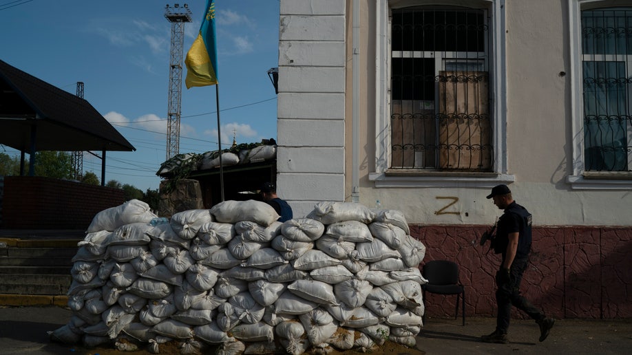A member of the State Emergency Service of Ukraine enters in the basement of the train station fortified with sand bags