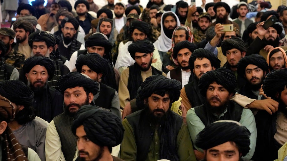 Taliban fighters and supporters attend a release ceremony for Bashir Noorzai