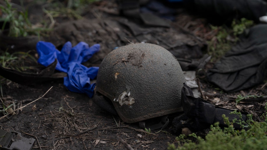A damaged helmet is seen on the ground of a site where four bodies of Ukrainian soldiers where found