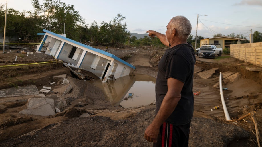 A home is seen collapsed into a hole in Puerto Rico