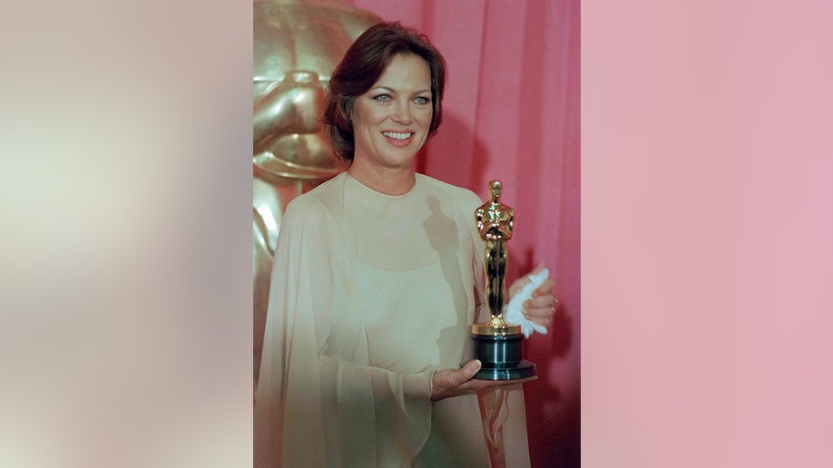 A photo of Louise Fletcher holding an Academy Award
