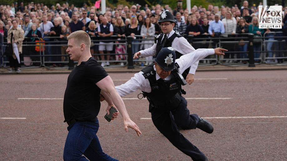 Police detain a man