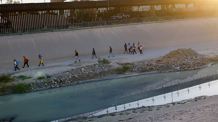 migrants walking along border
