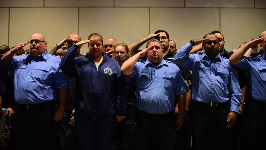 Men and women in uniform saluting