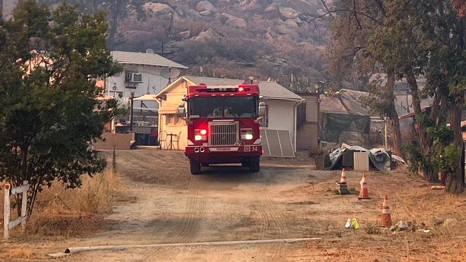 A fire trucks sits in front of the Fairview fire in California